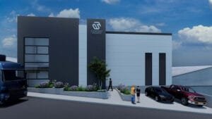 Render de la fachada de una nave industrial moderna, mostrando la entrada a las oficinas y vehículos estacionados al frente.
