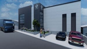 Render exterior de una nave industrial con diseño contemporáneo, mostrando su área de oficinas de dos pisos y el acceso a la bodega.