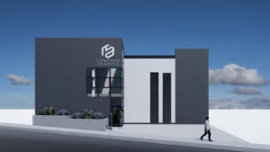 Render exterior de una nave industrial con diseño contemporáneo, mostrando su área de oficinas y el acceso a la bodega.